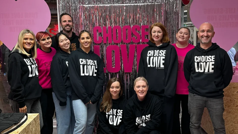Group photo of Insanity Talent Management team volunteering at a Choose Love pop-up shop.