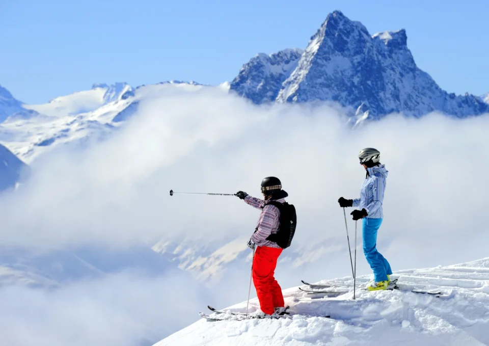 Two skiers look into the clouds in Austria, a destination for Crystal Ski, which was named Best Ski Operator in The Times Travel Awards 2024